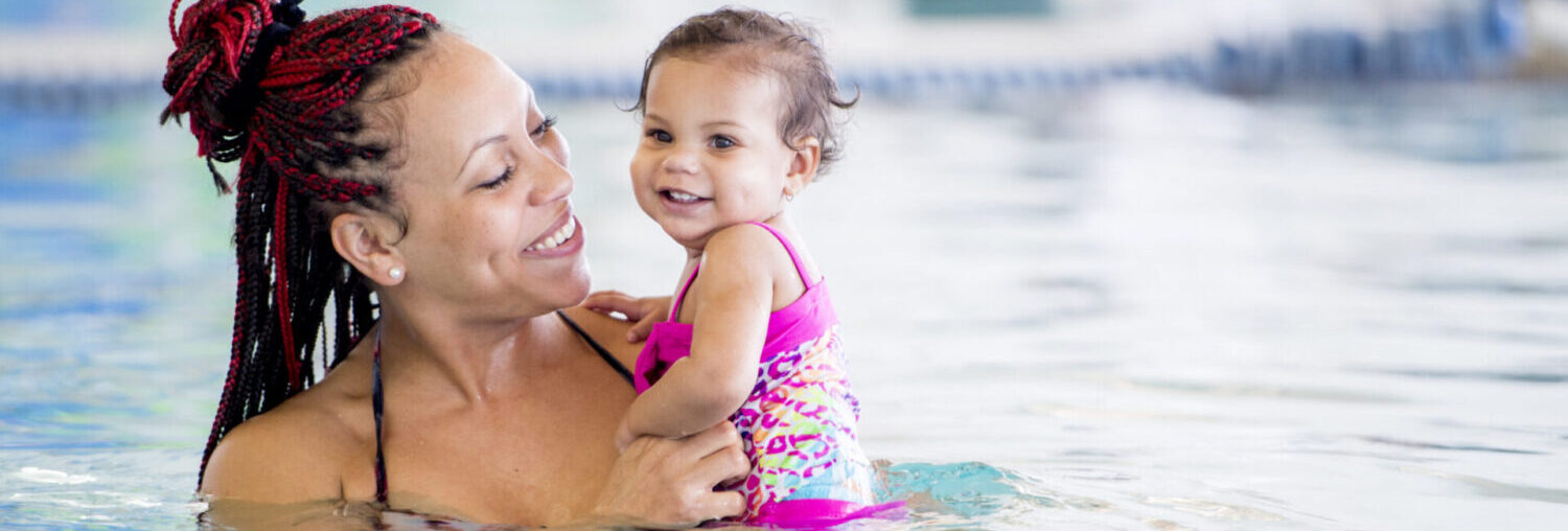 Mother and baby in pool